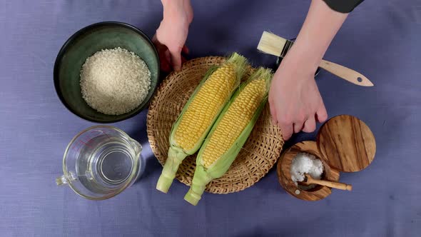 A Japanese female chef removes corns  at her home kitchen, Tokyo, Japan. July 2019. Camera fixed, cl