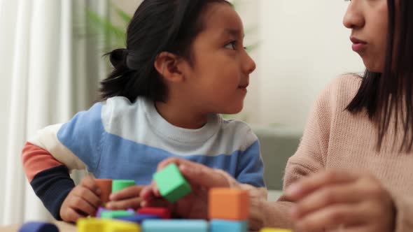 Happy Latin Mother and Kid Having Fun Playing Didactic Games at Home  Family Time Together