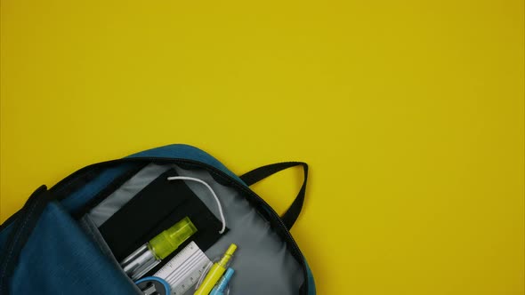 Blue Backpack with Colored School Supplies, a Fabric Mask and Hand Sanitizer. Stop Motion