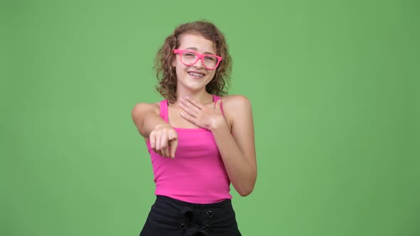 Young Happy Beautiful Nerd Woman Laughing While Pointing To Camera