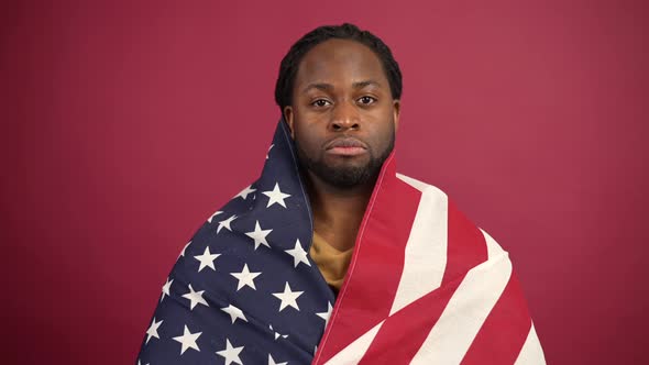 Confident African American Man Standing Covered with United States Flag