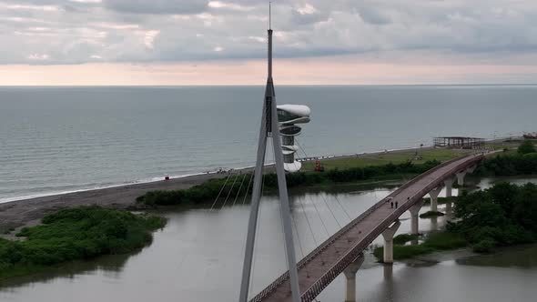 Anaklia, Georgia - July 16 2022: Aerial view of Anaklia-Ganmuhkuri Pedestrian Bridge at sunset