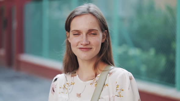 Portrait of Young Beautiful Happy Girl with Brown Hair and Blue Eyes with Freckles