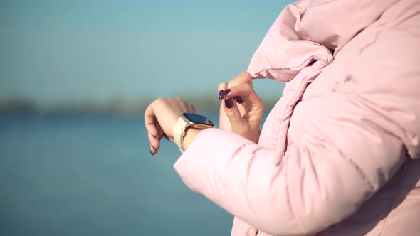 Female Checking Pulse On Smartwatch App. Girl Using Smart Watch Wearable Wristband Device.