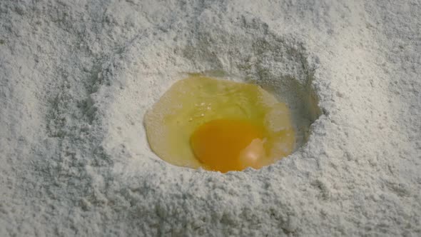 Egg Breaks Into Flour