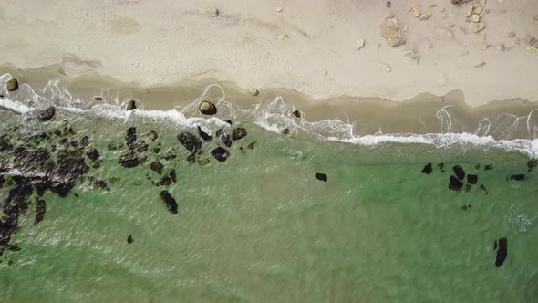 Aerial View of Rocky Beach and Sea Waves