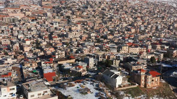 Hermon mountain ridge covered with snow during 2022 winter, with the town houses of Majd al Shams.