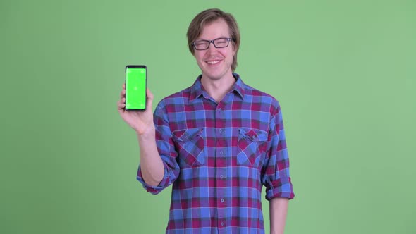 Happy Young Handsome Hipster Man Showing Phone