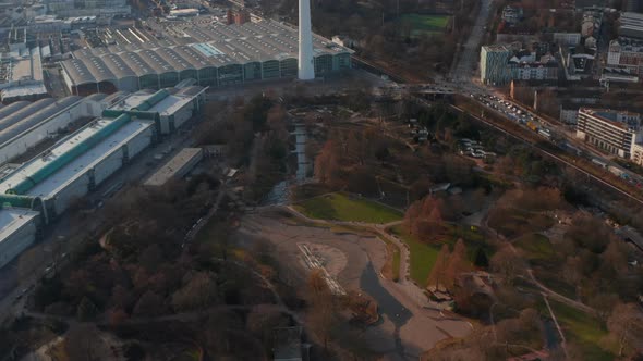 Aerial Reveal of Large Public Park in Front of Heinrich Hertz TV Tower and Urban City Center of