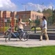 Happy Young Couple Stopped to Rest on a Bench After Cycling on a Sunny Summer Day - VideoHive Item for Sale