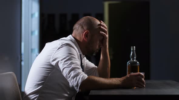 Wasted Alcoholic Man Drinking Whiskey at Home