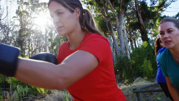 Woman practicing boxing in the boot camp