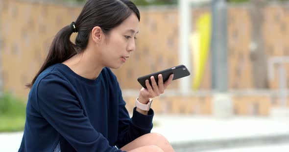 Young student look at mobile phone in university campus