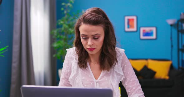 A Young Confused Businesswoman Works Remotely From Home