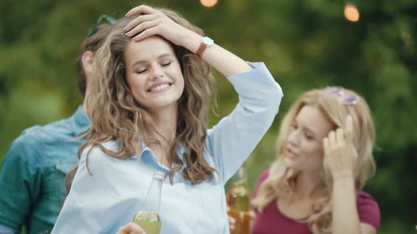 Beautiful Girl Dancing With Friends At Outdoor Party.