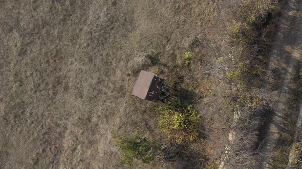 Descending on old water well in the field 4K drone video