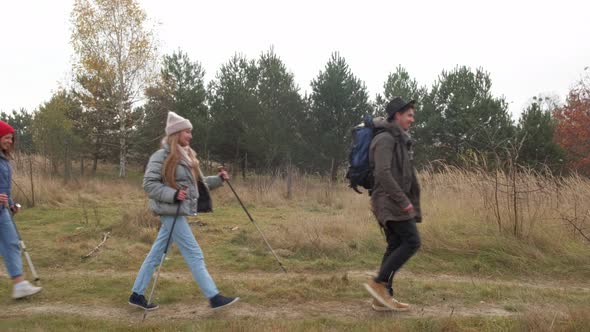 Group of Hikers Walking on a Mountain at Autumn Day