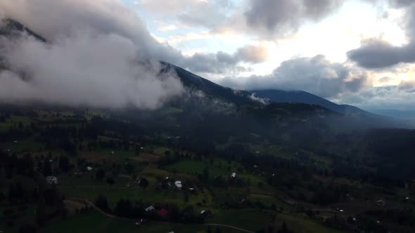 Dramatic Clouds Over Green Mountain Landscape, Aerial View