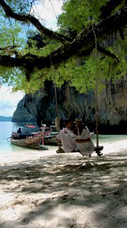 Couple Men and Woman on the Beach of Koh Hong Island Krabi Thailand Asian Woman and European Men on