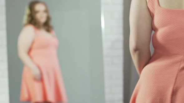 Girl With Extra Weight Admiring Reflection in Mirror, Blowing Kiss to Herself