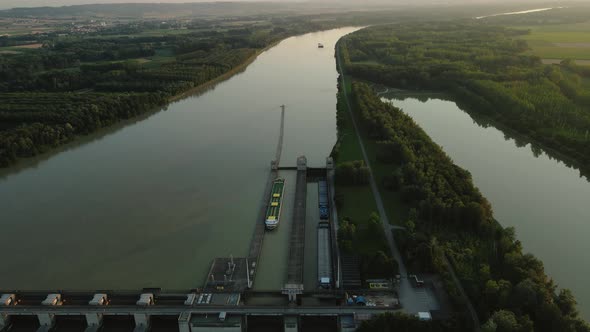 A cruise ship sitting in a lock on the Danube at sunset