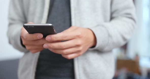 Woman working on smart phone at home