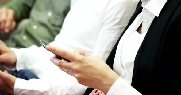 People using mobile phone and digital tablet in a modern office