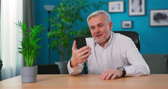 Old Middle Aged Man Having Video Chat Using Smartphone Chatting to Son on Mobile Phone