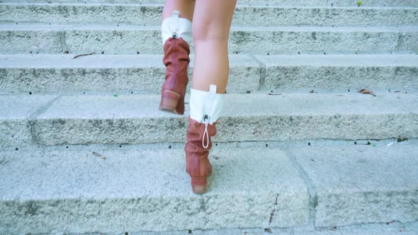 Woman Tourist Climbs Stairs with Wide Concrete Steps