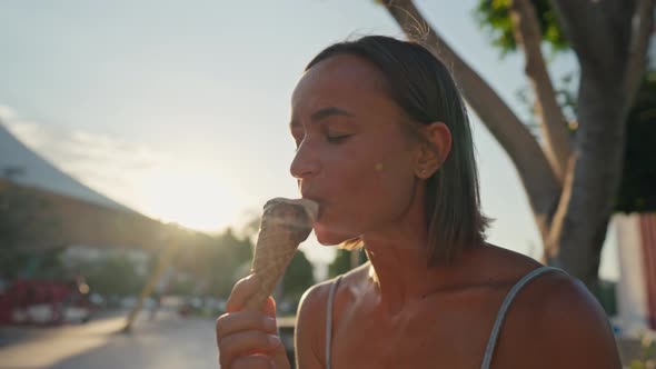 Beautiful Blond Girl Eating Ice Cream in Golden Hour