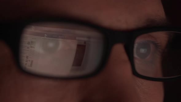 Website Reflecting in Glasses of Caucasian Male