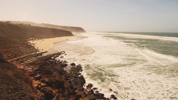 Aerial Drone View of Praia Grande Sandy Beach with Cliffs, showing Coastal Scenery and Coastline at