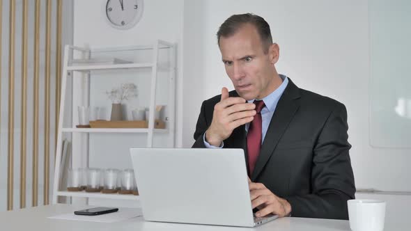 Shocked Middle Aged Businessman Working on Laptop Astonished