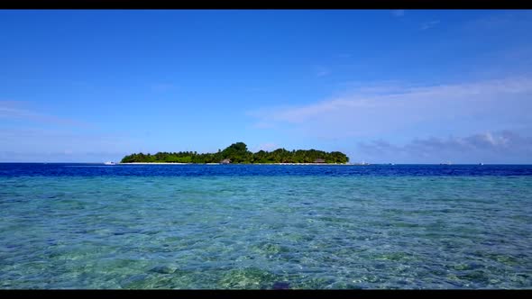 Aerial drone seascape of tranquil shore beach time by blue ocean with white sandy background of jour