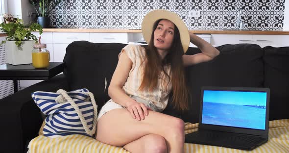 Young Woman Dreams of Sea Vacation in Light Apartment