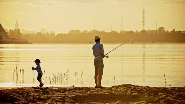 A Father and His Son on Fishing Together - a Man Holding the Rod and Fishing