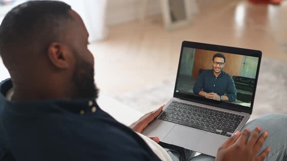 Male AfricanAmerican Job Seeker Involved Online Interview on the Laptop
