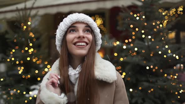 Smiling Girl Enjoying Snowfall 