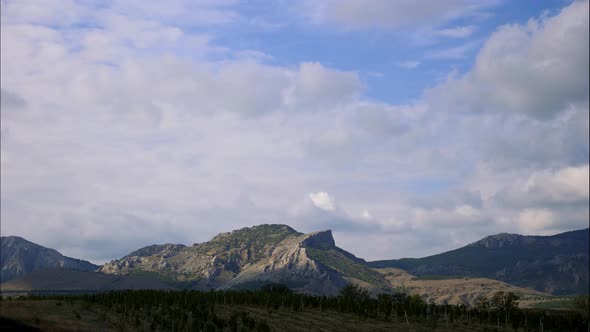 Mountains Against the Blue Sky with White Clouds. Cirrus Clouds Run Across the Blue Sky. Best Types