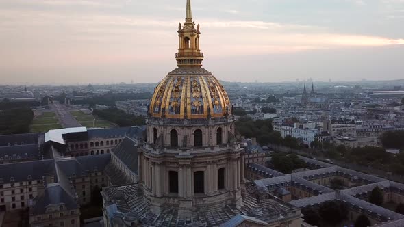 Aerial Orbit of Les Invalides Golden Dome at sunrise, Revealing Eiffel Tower in the Paris city in ba