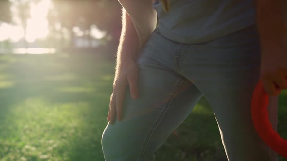 Closeup Man Hand Patting Leg in Golden Sunlight Park