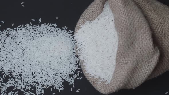 Rice Pours Out Of Falling Sack On Black Table 