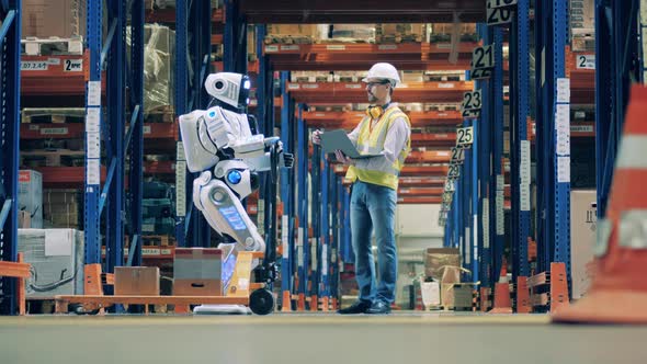 Male Engineer Is Operating a Cyborg in the Warehouse Unit