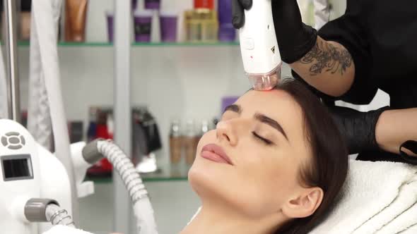 Lovely Female in Beauty Salon Receiving Facial Procedures