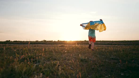 Cute Little Boy  Ukrainian Patriot Kid Running with National Flag on Open Area Field