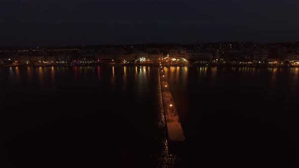 Aerial night view of resort and pier in the sea