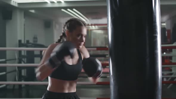 Boxing, Female Fighter Trains His Punches, Beats a Punching Bag, Training Day in the Boxing Gym