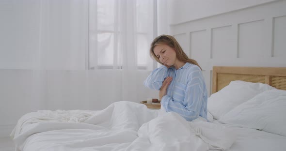 Young Woman Lying in Bed in Morning Feels Pain in Neck After Night Sleep, Awaken Having Painful