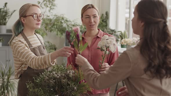 Florists Offering Flowers to Client