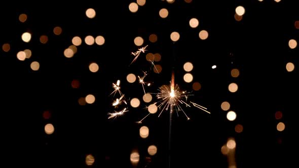 Sparkler against Bokeh Lights